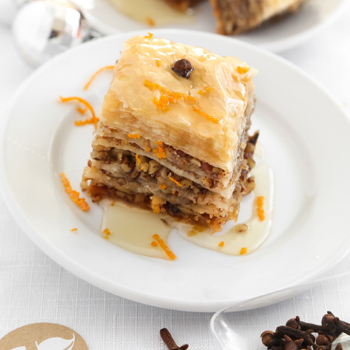 This Greek Baklava recipe has walnuts and cinnamon layered between flaky phyllo dough brushed with melted butter then baked and drizzled with a sugar and honey syrup to create a crispy, sweet, and impressive dessert!